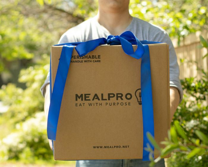 image of a man holding a delivery box