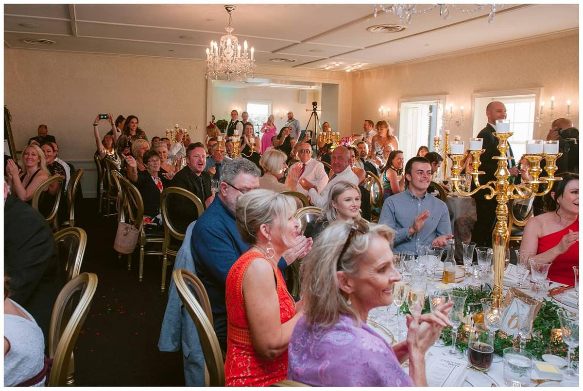 Guests clapping and cheering during a heartfelt wedding speech at Dunbar House Watsons Bay.